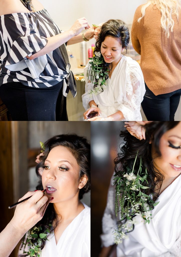 Bride getting florals put in her long brown hair for her wedding updo. 