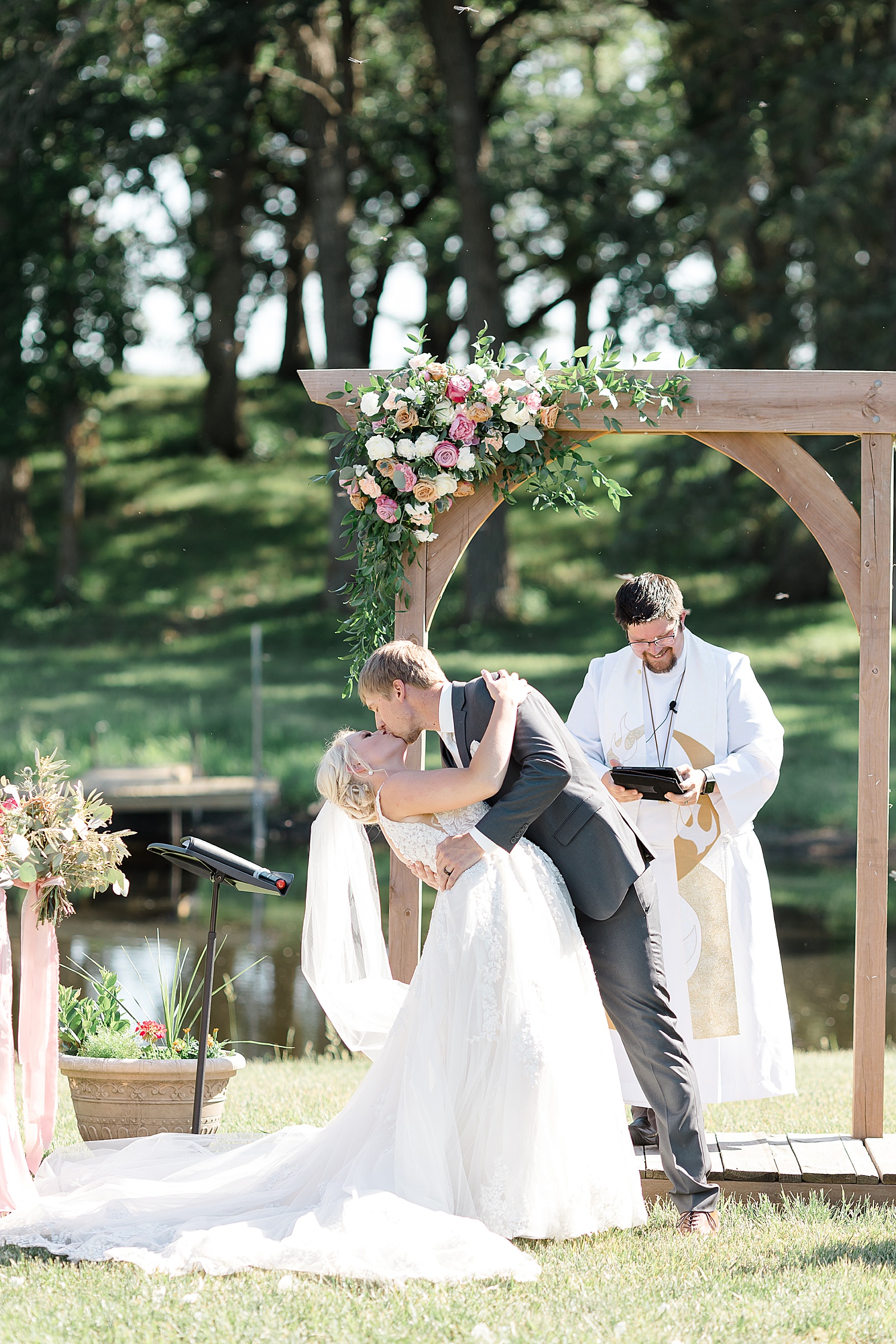 Newlyweds share their first kiss at Hitching Post Minnesota Wedding
