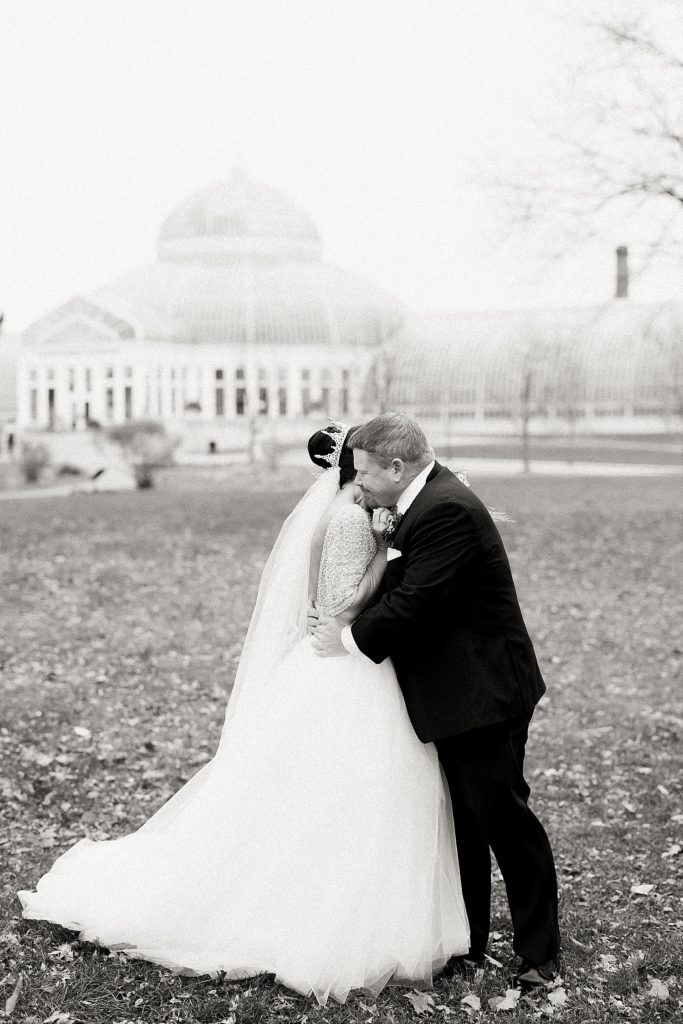 Groom hugging bride at their Minneapolis Como Park Zoo & Conservatory Wedding