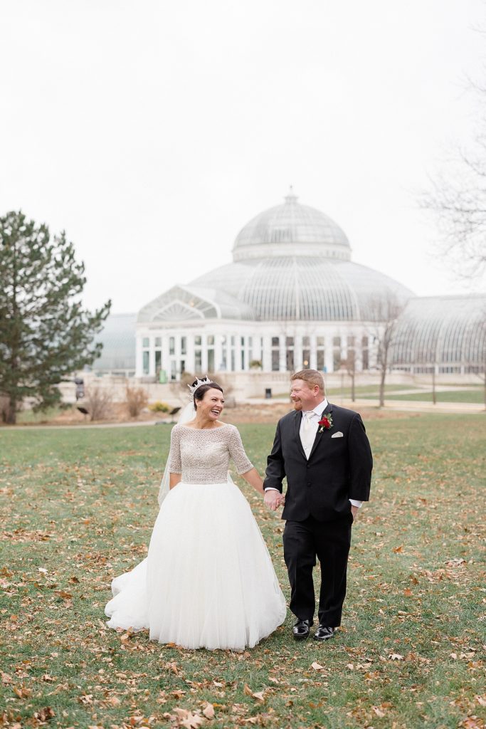 Bride and groom walking in front of Minneapolis Como Park Zoo & Conservatory Wedding