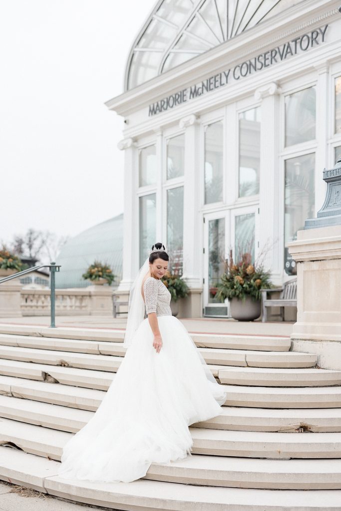 Bride standing on the steps before her Minneapolis Como Park Zoo & Conservatory Wedding