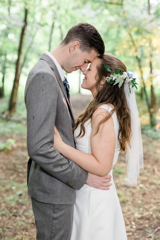 Groom and bride hugging in the woods by Fernweh & Liebe